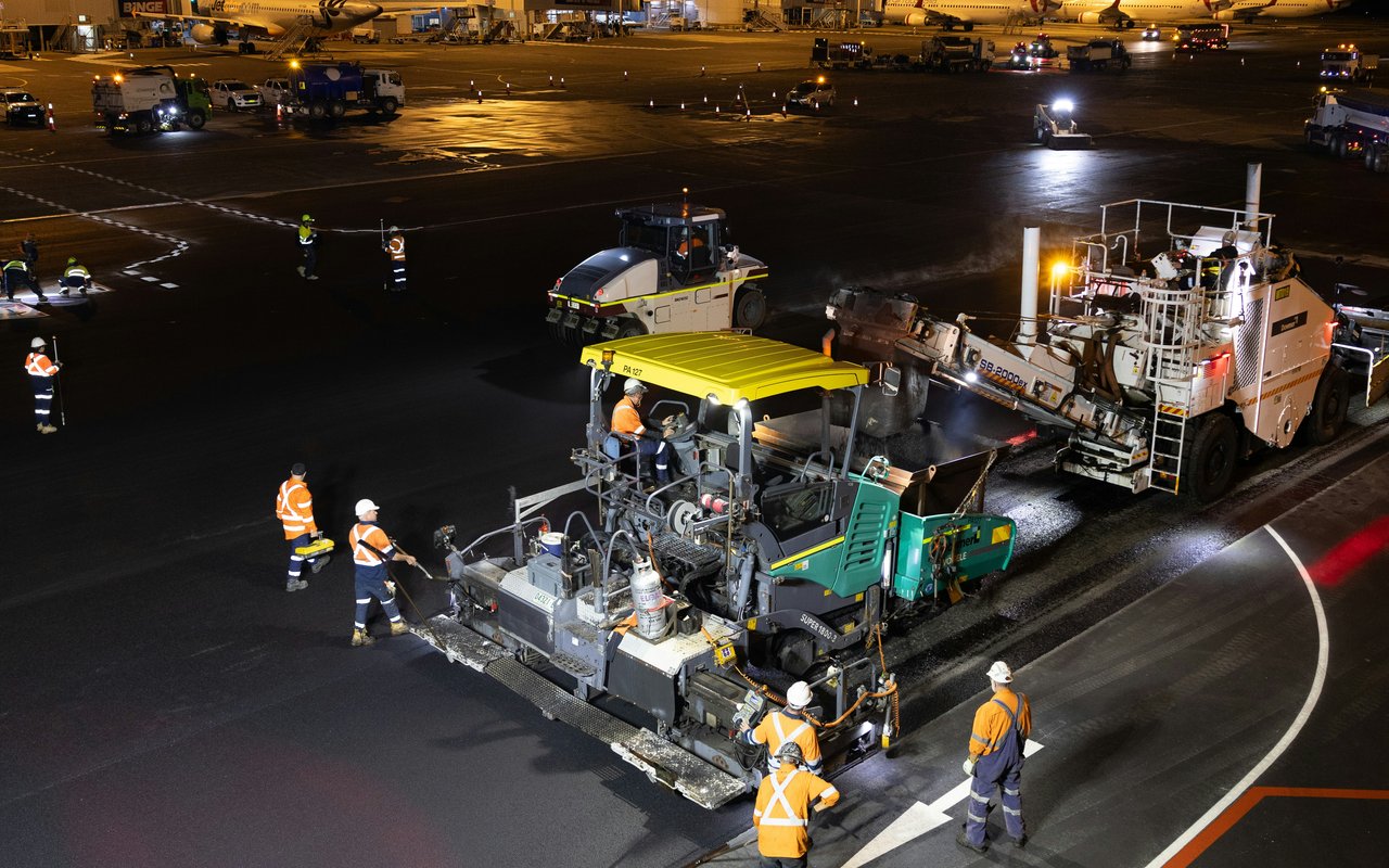 Nighttime airfield paving work at an airport apron